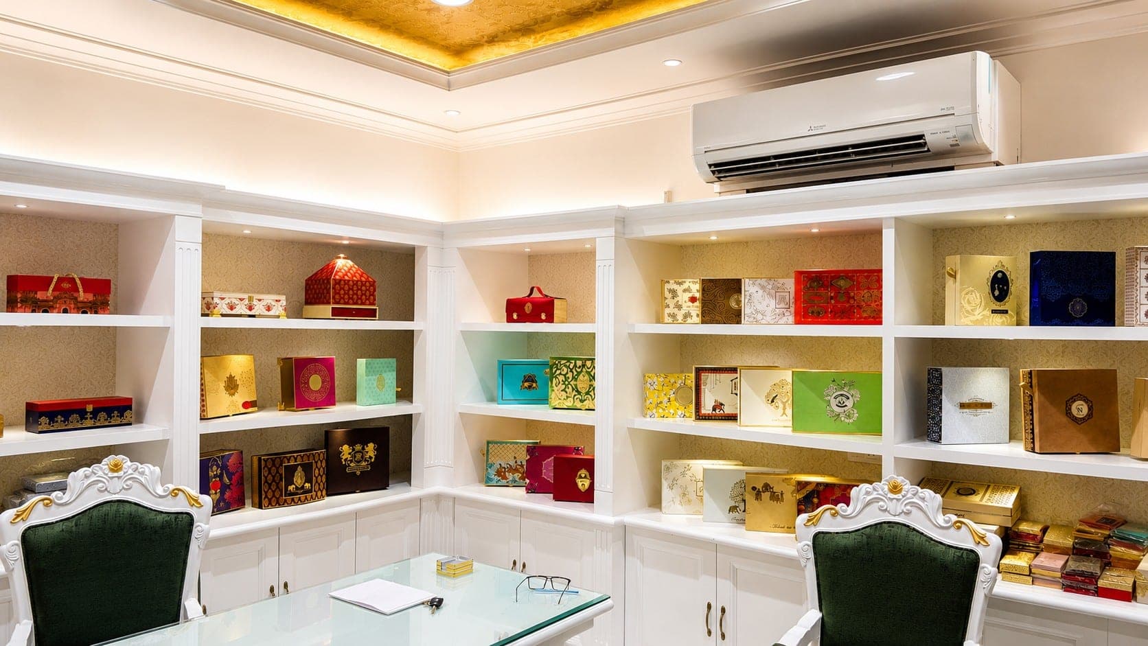 Sentiments Card Gallery wedding card showroom in Khanna — white built-in shelving, gold damask ceiling and emerald green velvet chairs